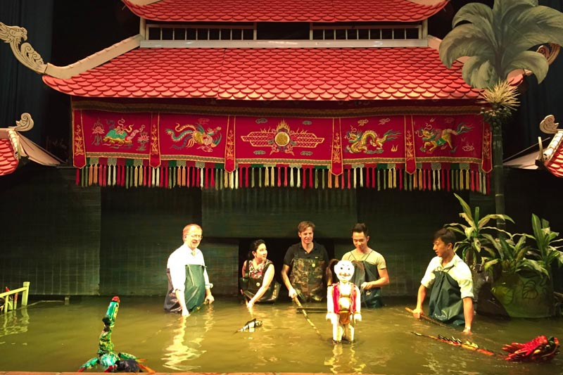 Tourist perform water puppets Tourist perform water puppets vietnam holidays