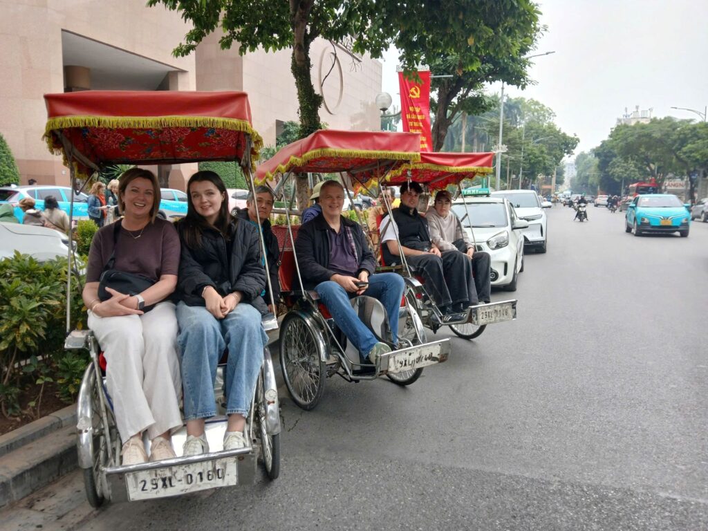 Nadova Tours client enjoying a cyclo ride around Hoàn Kiếm Lake.