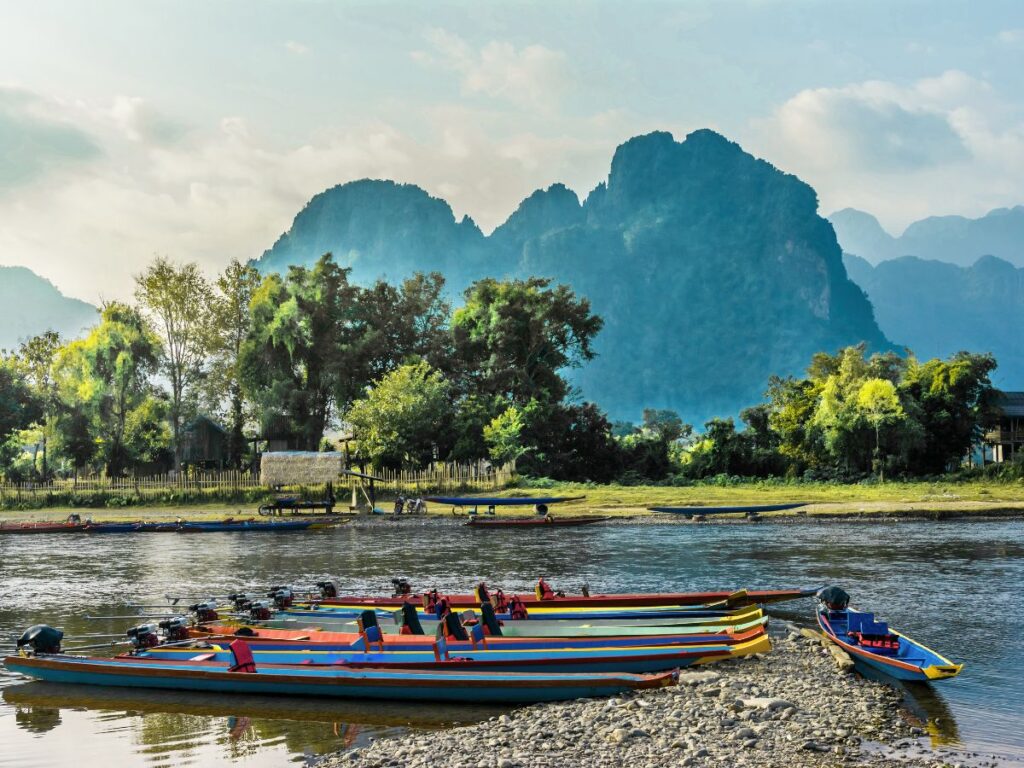 Colorful boats on the banks of the Nam Song River, in Vang Vieng, Laos